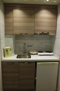 a kitchen with a sink and a stove and cabinets at Amphi Apart in Marmaris