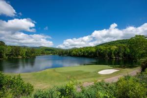 a golf course with a view of a lake at Whispering Knoll - Jasper, GA - Enjoy Peaceful Forest Views, Settle in for Movie Night in the Private Theater Room, Stay Active in Jasper