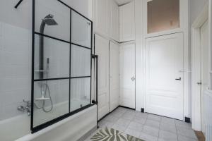 a bathroom with a shower and a glass door at Westersingel in Rotterdam +33 photos