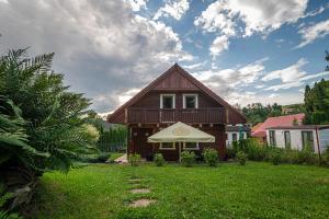a house with a tent in front of a yard at Chalet Mara Liptov in Otilia