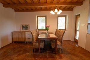 a dining room with a wooden table and chairs at Chalet Mara Liptov in Otilia +10 photos