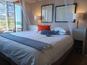 ein Bett mit zwei Kissen darauf in einem Schlafzimmer in der Unterkunft Absolute Beach Accommodation in Stompneusbaai + 26 Fotos