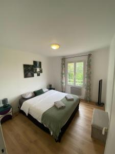 a bedroom with a large bed and a window at Villa Mel's in Bannay