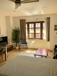 ein Schlafzimmer mit einem Bett, einem Tisch und einem Stuhl in der Unterkunft Apartamentos Marques de Teverga , Oviedo centro in Oviedo