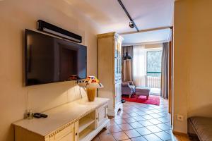 sala de estar con TV de pantalla plana grande en la pared en Boutique Appartements, en Saalbach Hinterglemm