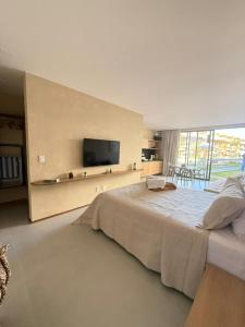 ein großes Schlafzimmer mit einem großen Bett und einem Flachbild-TV in der Unterkunft Tatuamunha - River03 - Vila Boutique Naay in Tatuamunha