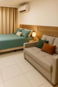 a living room with two beds and a couch at Studio com piscina Centro Rio de Janeiro in Rio de Janeiro