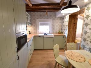 a kitchen with a table and a dining room at Aquí me quedo Catedral in Burgos