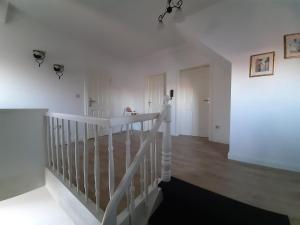 a white room with a staircase and a white wall at City Fewo Stricker in Bad Sachsa