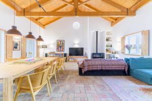 a living room with a table and chairs and a couch at Casa do Medronheiro in Melides