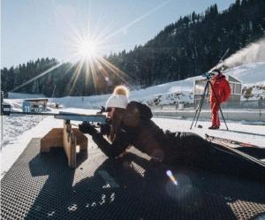 a person laying in the snow with a gun at L'Aurore de Vouglans 4-5 Personnes in Pont-de-Poitte