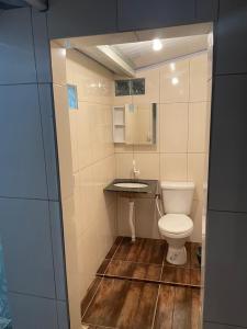 a small bathroom with a toilet and a sink at Suíte rural in Foz do Iguaçu +36 photos