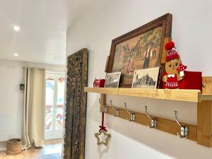 a shelf on the wall in a room at La Poulie - Apartment with Balcony and Free Privative Parking - Close to Colmar in Sainte-Croix-en-Plaine +23 photos
