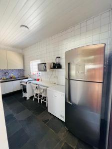 eine Küche mit einem Kühlschrank aus Edelstahl in der Unterkunft Casa na praia do Guaiuba in Guarujá + 10 Fotos