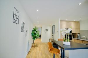 a kitchen and living room with a table and chairs at Modern & Hypercentre, Private Balcony in Saint-Étienne
