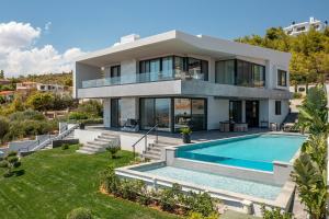 an image of a house with a swimming pool at Aurora Residence by A&D Properties in Neos Voutzas