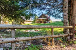 a wooden fence in front of a house at Mountain lodge Pokljuka in Bohinjska Bistrica