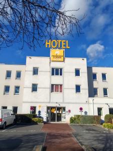 a building with a hotel sign on top of it at Premiere Classe Caen Nord - Mémorial in Caen