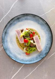 a plate of food with meat and vegetables on it at Hôtel La Villa Douce in Rayol-Canadel-sur-Mer +60 photos