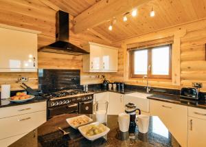 a kitchen with a stove and a counter top at Laxfield Lodges in Laxfield