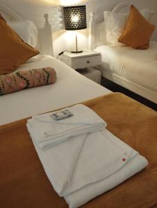 a white shirt is sitting on a bed at Eira da Mila in Coimbra +28 photos