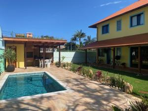 a house with a swimming pool in front of a house at Venere - Bed and Breakfast in Florianópolis