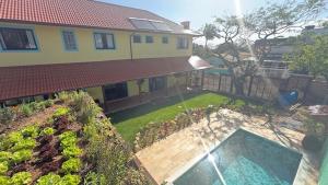 an aerial view of a house with a swimming pool at Venere - Bed and Breakfast in Florianópolis +15 photos