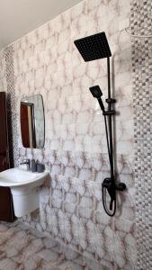 Un baño con lavabo, espejo y ducha. en Marsa wadi shab, en Ash Shāb