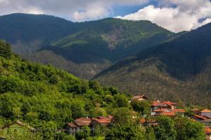 a group of houses in front of a mountain at Corte Girodo - Appartamento Girasole in Rubiana