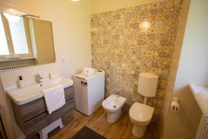 a bathroom with a sink and a toilet at Corte Girodo - Appartamento Girasole in Rubiana +9 photos