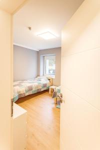 a bedroom with a bed and a window at Ferienwohnung Las Vegas in Marienheide +3 photos