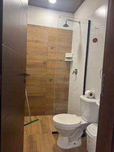 a bathroom with a toilet and a glass shower at Mar Adentro Casa 5 in Santa Cruz de la Sierra