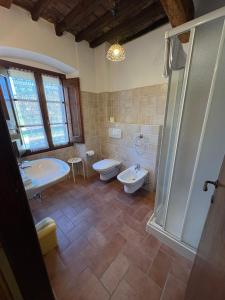 a bathroom with a tub and a toilet and a sink at Molenda B&B in Città di Castello +64 photos