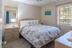 una camera da letto con un letto, un comò e uno specchio di Charming Golf Getaway! River Oaks 19E a Myrtle Beach Altre 14 foto