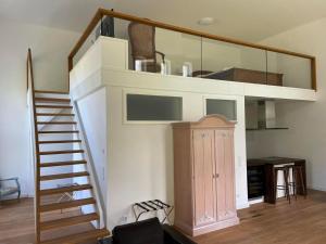 a room with a staircase leading up to a loft at Weisses Traumschloss An Der Ostsee in Hohendorf +8 photos
