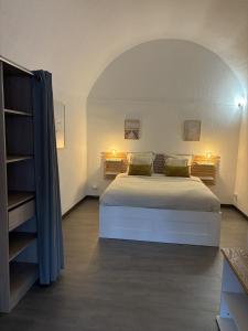 a bedroom with a large bed and a book shelf at Spacieux duplex sur le port in Gruissan
