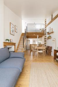 a living room with a blue couch and a table at Maison atypique - Au coeur de la vieille ville in Le Puy en Velay