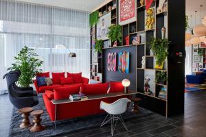 a living room with a red couch and a table at citizenM Washington DC NoMa in Washington, D.C. +31 photos