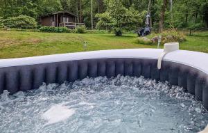 a pool with a water fountain in a backyard at Pet Friendly Home In Söderköping in Söderköping