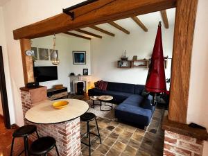 a living room with a blue couch and a table at Ground floor in Brussels