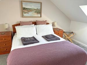 a bedroom with a large bed with two towels on it at Bay - Uk44720 in Ravenscar
