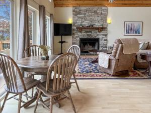 a living room with a table and chairs and a fireplace at Amazing Views Fire Pit & Grill near Wardensville in Delray