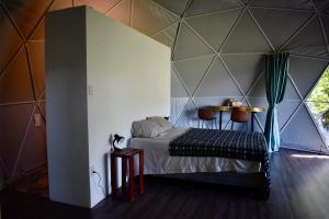 a room with a bed in a tent at Casita Anya in Hone Creek