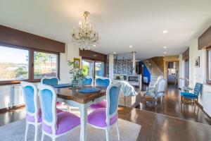 une salle à manger avec une table et des chaises dans l'établissement Villa Carolina Luxury Singular, à Basoñas