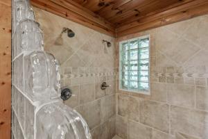 a bathroom with a shower with a glass at Sugar Bear Lodge in Banner Elk +41 photos