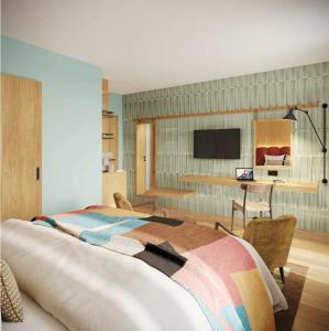 a bedroom with a large bed and a desk at Hotel Alpina Luzern in Luzern