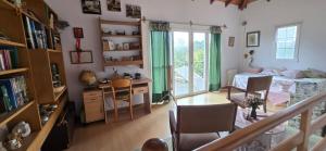 ein Wohnzimmer mit Bett und Schreibtisch und ein Schlafzimmer in der Unterkunft Los Alerces, Villa Berna in La Porteña