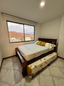 En eller flere senge i et værelse på Apartamento MI ATARDECER