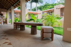 a patio with a wooden table and a chair at Casa Nära Hotel in El Sucio