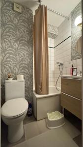 a bathroom with a toilet and a shower and a sink at Paris Home in Bussy-Saint-Georges